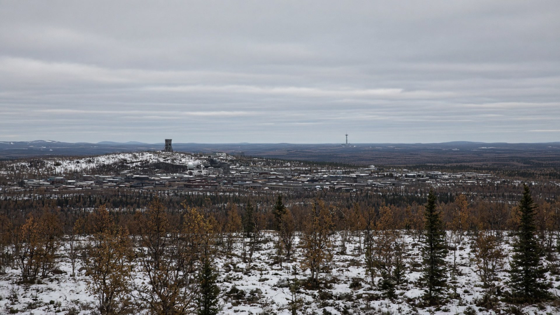 Kiruna industrial town under cold autumn sky, distant pad tower.